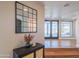 A foyer with hardwood floors, decorative mirror, and a view into the living spaces at 30600 N Pima Rd # 19, Scottsdale, AZ 85266