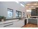 Modern kitchen showcasing quartz counters, high ceilings, sleek cabinetry, and clerestory windows at 30600 N Pima Rd # 19, Scottsdale, AZ 85266