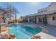 Resort-style pool area with rock accents, desert plants, and a private patio at 30600 N Pima Rd # 19, Scottsdale, AZ 85266