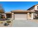 Charming single-story home featuring a tile roof, stone accents, desert landscaping, and a two-car garage at 3650 W Denali Dr, Anthem, AZ 85086