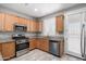 Well-lit kitchen features stainless appliances, granite counters, and wood cabinets at 3650 W Denali Dr, Anthem, AZ 85086