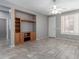 Open living area with tile flooring, a ceiling fan, and a built-in entertainment center at 3650 W Denali Dr, Anthem, AZ 85086