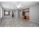 Open living area with tile flooring, a ceiling fan, and a built-in entertainment center at 3650 W Denali Dr, Anthem, AZ 85086