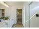 Bathroom featuring double vanity sinks, walk-in closet and glass enclosed shower at 39237 N Acadia Way, Anthem, AZ 85086