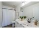 Clean bathroom with a shower, white vanity, and a decorative fern at 39237 N Acadia Way, Anthem, AZ 85086