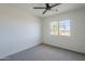 Well-lit bedroom with a ceiling fan and a window providing natural light at 39237 N Acadia Way, Anthem, AZ 85086