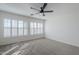 Bright bedroom featuring plantation shutters, neutral walls, and a modern ceiling fan for comfortable living at 39237 N Acadia Way, Anthem, AZ 85086