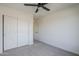 Neutral bedroom featuring carpet, a ceiling fan and a closet with sliding doors at 39237 N Acadia Way, Anthem, AZ 85086