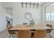 Bright dining area featuring a modern chandelier, wooden table, and comfortable seating at 39237 N Acadia Way, Anthem, AZ 85086