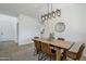 A dining room with a wooden table and pendant lighting that adds style to the space at 39237 N Acadia Way, Anthem, AZ 85086