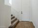 Entryway features a staircase with carpeted steps, tile floors, and a white front door at 39237 N Acadia Way, Anthem, AZ 85086