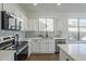 Bright and updated kitchen featuring stainless steel appliances, quartz countertops, and subway tile backsplash at 39237 N Acadia Way, Anthem, AZ 85086