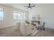 Bright living room features neutral walls, a large window, and comfortable seating around a coffee table at 39237 N Acadia Way, Anthem, AZ 85086