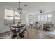 Open floorplan includes kitchen nook with table and chairs adjacent to living room with ceiling fan at 39237 N Acadia Way, Anthem, AZ 85086