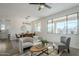 Spacious living room features neutral walls, a ceiling fan, and an open dining area with natural light at 39237 N Acadia Way, Anthem, AZ 85086