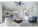 Stylish living room with open shelving, plush seating, and a seamless connection to the modern kitchen at 39237 N Acadia Way, Anthem, AZ 85086