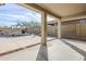 Outdoor patio leading to a backyard pool featuring a waterfall and desert landscape at 39237 N Acadia Way, Anthem, AZ 85086