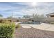 Sparkling pool features rock detail with mature landscaping at 39237 N Acadia Way, Anthem, AZ 85086