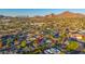 Aerial shot of neighborhood with mountain views and vibrant green trees at 3931 E Glenrosa Ave, Phoenix, AZ 85018