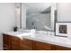 Bathroom vanity with double sinks, marble countertop, wood cabinets, and a large mirror at 3931 E Glenrosa Ave, Phoenix, AZ 85018