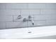 Close-up of a sleek, modern chrome faucet with white subway tile backsplash at 3931 E Glenrosa Ave, Phoenix, AZ 85018