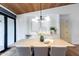 Dining room with modern light fixture and long wooden table with seating for eight at 3931 E Glenrosa Ave, Phoenix, AZ 85018