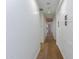 Long hallway with hardwood floors and white walls leading to various rooms at 3931 E Glenrosa Ave, Phoenix, AZ 85018