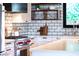 Close up of the kitchen with stainless steel Wolf range, sink, and subway tile backsplash at 3931 E Glenrosa Ave, Phoenix, AZ 85018