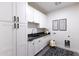 Functional laundry room with white cabinets, a sink, and decorative art at 3931 E Glenrosa Ave, Phoenix, AZ 85018