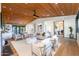 Spacious living room with wood ceiling, fireplace, modern furniture, and seamless flow into the dining area at 3931 E Glenrosa Ave, Phoenix, AZ 85018