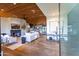 Open-concept living room with a fireplace, wood ceiling, and seamless flow to the kitchen at 3931 E Glenrosa Ave, Phoenix, AZ 85018