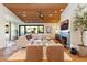 Inviting living room featuring a cozy fireplace, wood ceiling, modern furniture, and ample natural light at 3931 E Glenrosa Ave, Phoenix, AZ 85018