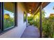 Inviting covered porch with stylish lighting and a glimpse of the lush outdoor greenery at 3931 E Glenrosa Ave, Phoenix, AZ 85018