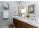 Chic powder room with marble countertop, wood vanity, and stylish decor at 3931 E Glenrosa Ave, Phoenix, AZ 85018