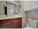 Compact bathroom featuring a single sink vanity and overhead cabinet storage at 3935 E Rough Rider Rd # 1055, Phoenix, AZ 85050