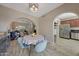 Bright dining area with arched openings leading to the living room and stainless steel appliances at 3935 E Rough Rider Rd # 1055, Phoenix, AZ 85050