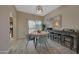 Comfortable dining area featuring a round table, bar seating, and natural light from the sliding glass door at 3935 E Rough Rider Rd # 1055, Phoenix, AZ 85050