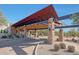 Impressive covered entrance with stone pillars, showcasing community architecture and landscaping at 3935 E Rough Rider Rd # 1055, Phoenix, AZ 85050