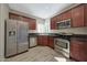 Well-lit kitchen with stainless steel appliances, granite countertops, and warm wood cabinets at 3935 E Rough Rider Rd # 1055, Phoenix, AZ 85050