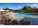 A large, resort-style pool with lounge chairs, umbrellas, and lush landscaping for relaxation and leisure at 3935 E Rough Rider Rd # 1055, Phoenix, AZ 85050