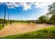 Outdoor sand volleyball court on manicured grass with bright blue sky and trees in the background at 3935 E Rough Rider Rd # 1055, Phoenix, AZ 85050