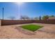 Expansive backyard features a section of artificial grass, perfect for outdoor enjoyment at 41375 W Barcelona Dr, Maricopa, AZ 85138