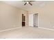 Spacious bedroom featuring wood-look floors and doors leading to the bathroom and closet at 41375 W Barcelona Dr, Maricopa, AZ 85138