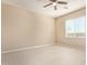 Bright bedroom featuring wood-look floors, a ceiling fan, and a large window for natural light at 41375 W Barcelona Dr, Maricopa, AZ 85138