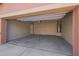 Spacious two-car garage featuring concrete flooring and an included water heater at 41375 W Barcelona Dr, Maricopa, AZ 85138