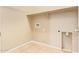 A functional laundry room with tiled flooring and a built-in shelf for added convenience and storage solutions at 41375 W Barcelona Dr, Maricopa, AZ 85138