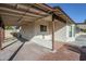 View of the backyard with a covered patio and brick pavers at 4501 E Osage Ct, Phoenix, AZ 85044