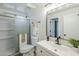 A well-lit bathroom featuring a walk-in shower and modern vanity at 4501 E Osage Ct, Phoenix, AZ 85044