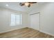 Bedroom featuring wood look floors, a window with blinds, a ceiling fan, and closet at 4501 E Osage Ct, Phoenix, AZ 85044