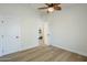 A bright bedroom featuring wood-look floors and a modern ceiling fan at 4501 E Osage Ct, Phoenix, AZ 85044